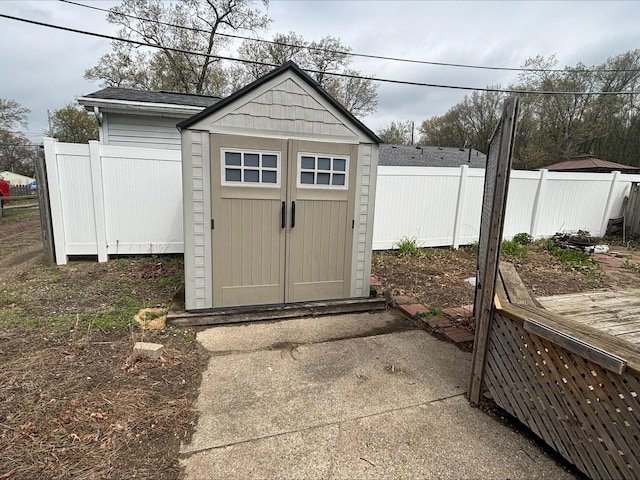 view of shed featuring fence