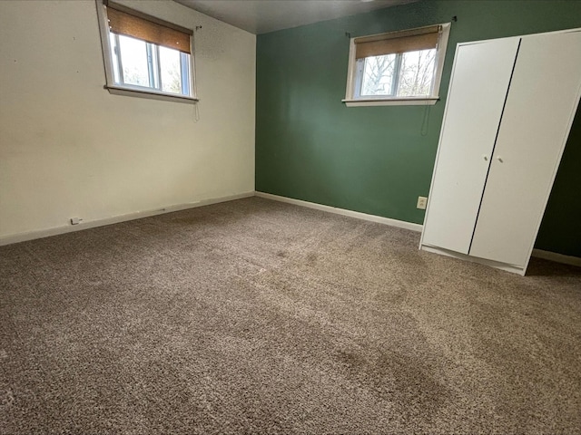 interior space with carpet floors, baseboards, and a closet