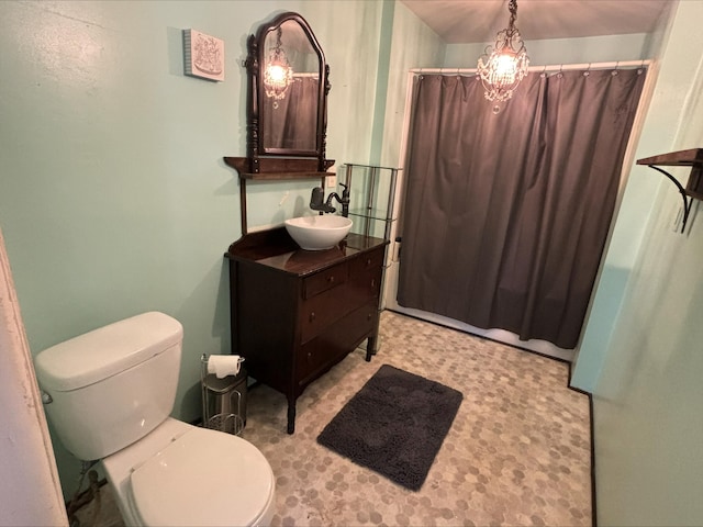 bathroom featuring vanity, a shower with shower curtain, tile patterned floors, and toilet