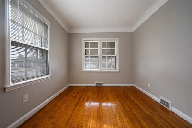 5534 Oldtown St, Detroit, MI 48224 - empty room with visible vents, plenty of natural light, and hardwood / wood-style flooring