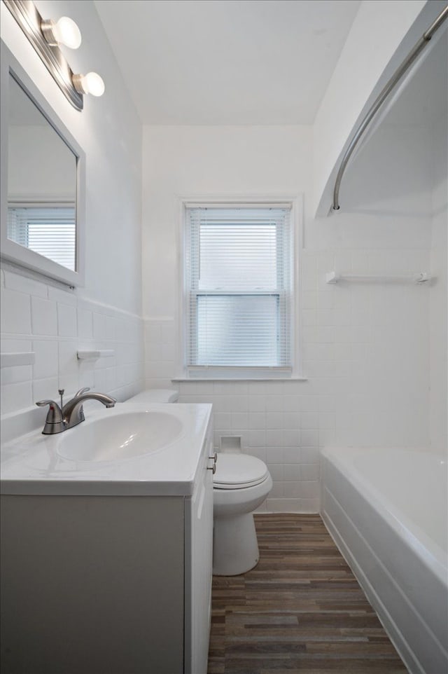 5534 Oldtown St, Detroit, MI 48224 - bathroom featuring toilet, tile walls, plenty of natural light, and vanity