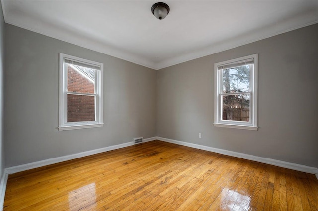 5534 Oldtown St, Detroit, MI 48224 - empty room featuring crown molding, a wealth of natural light, light wood-type flooring, and visible vents