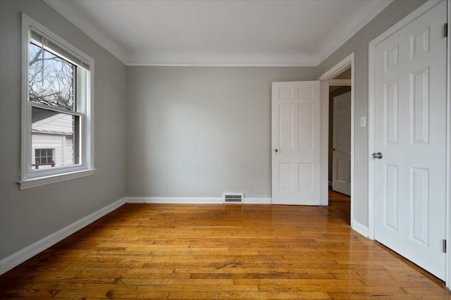 5534 Oldtown St, Detroit, MI 48224 - unfurnished room with crown molding, baseboards, light wood-type flooring, and visible vents