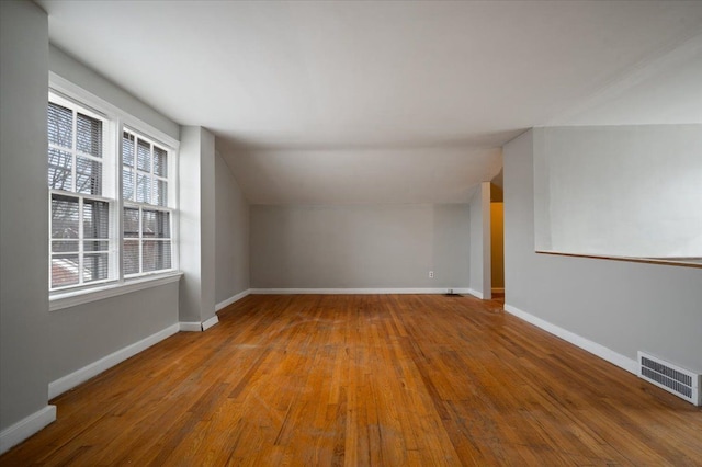 5534 Oldtown St, Detroit, MI 48224 - bonus room featuring baseboards, lofted ceiling, wood finished floors, and visible vents