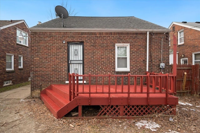 5534 Oldtown St, Detroit, MI 48224 - back of property featuring brick siding, roof with shingles, and a wooden deck