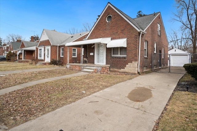 5534 Oldtown St, Detroit, MI 48224 - view of front facade with brick siding, a garage, concrete driveway, and an outdoor structure