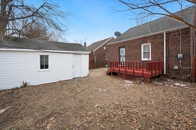 5534 Oldtown St, Detroit, MI 48224 - rear view of property with brick siding, a wooden deck, an outdoor structure, and roof with shingles