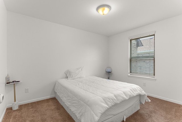 carpeted bedroom featuring baseboards