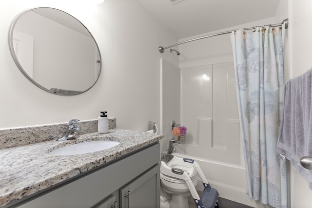 bathroom featuring toilet, shower / tub combo, and vanity