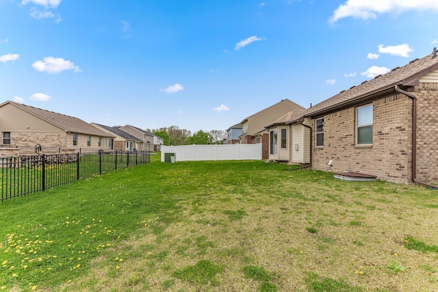 view of yard with a fenced backyard and a residential view