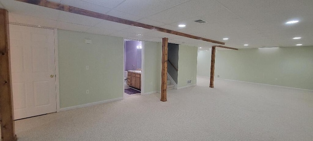 finished basement featuring light colored carpet, stairway, visible vents, and recessed lighting