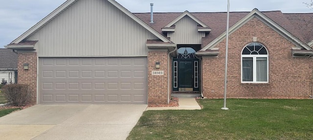 view of front of property featuring brick siding, a garage, a front lawn, and concrete driveway