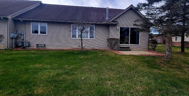 rear view of house featuring a yard, a patio, and roof with shingles