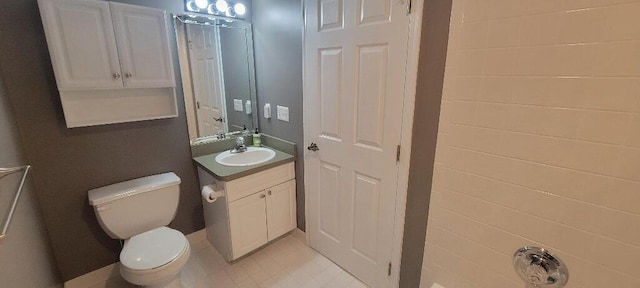bathroom with vanity, tile patterned floors, and toilet