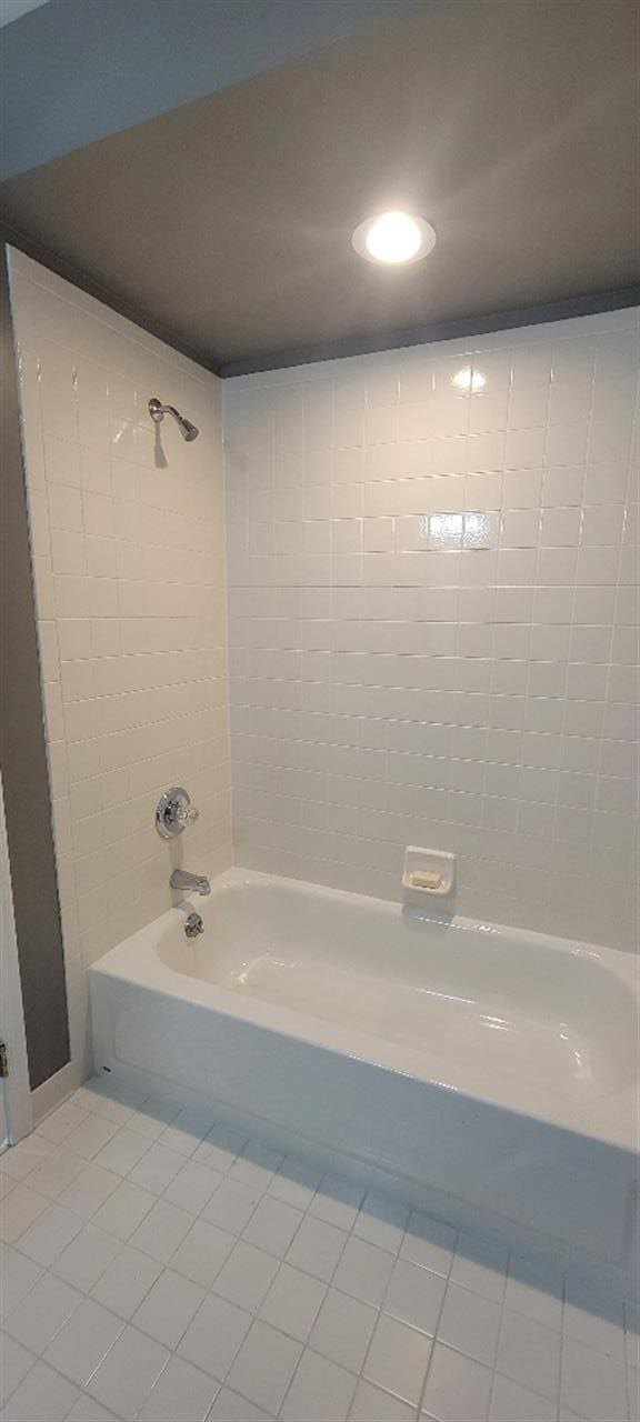 full bath with recessed lighting, shower / tub combination, and tile patterned flooring