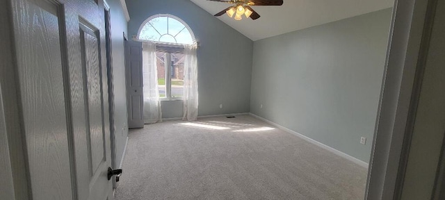 spare room with carpet floors, baseboards, ceiling fan, and vaulted ceiling