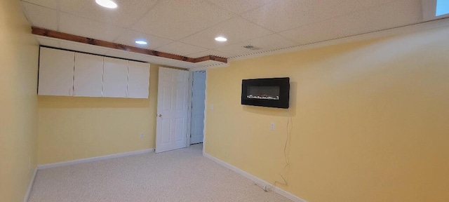 basement with light colored carpet, recessed lighting, baseboards, a drop ceiling, and visible vents