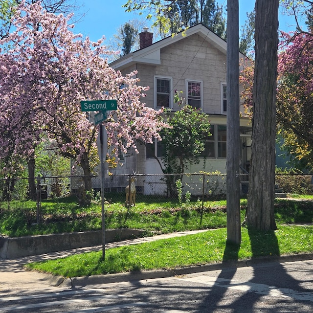 view of front of house with fence and a chimney