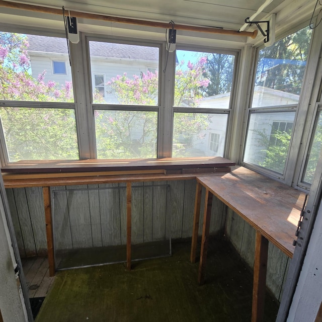 unfurnished sunroom with a healthy amount of sunlight and wood finished floors