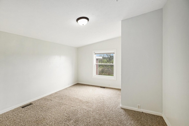 unfurnished room with carpet floors, baseboards, visible vents, and vaulted ceiling