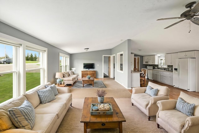 living room with ceiling fan and lofted ceiling