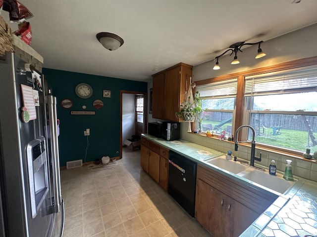kitchen with tile countertops, visible vents, dishwasher, a sink, and stainless steel fridge with ice dispenser