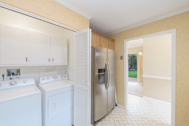 clothes washing area featuring baseboards, separate washer and dryer, crown molding, and cabinet space