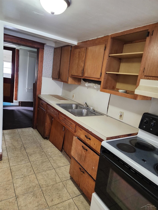 kitchen with ventilation hood, a sink, light countertops, range with electric cooktop, and brown cabinetry