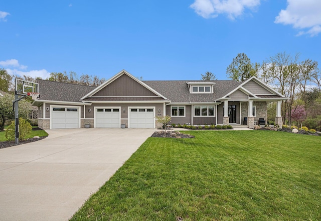 craftsman-style home with roof with shingles, stone siding, a garage, a front yard, and driveway