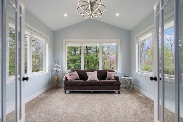 sunroom featuring an inviting chandelier, french doors, and visible vents