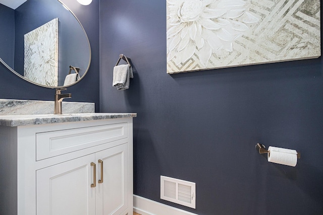 bathroom with visible vents, baseboards, and vanity