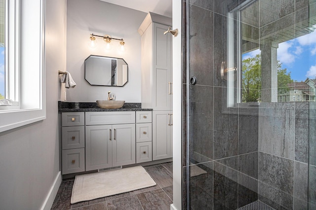 full bathroom featuring vanity, visible vents, wood finished floors, baseboards, and a shower stall