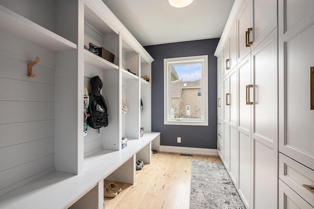 mudroom with baseboards and light wood-type flooring