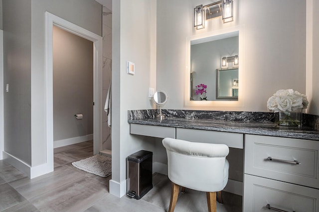bathroom with baseboards and vanity