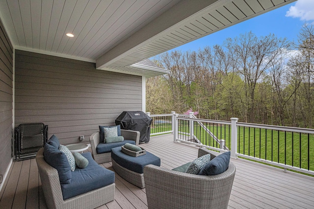 wooden deck with a yard and a grill