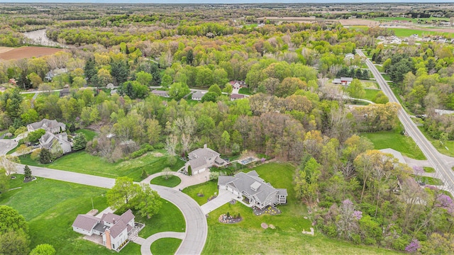 birds eye view of property featuring a wooded view