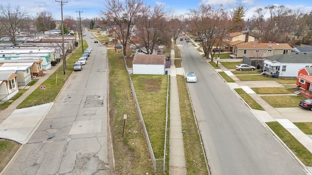 view of asphalt street featuring a residential view, sidewalks, and curbs