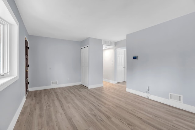 unfurnished living room with light wood-style floors and baseboards
