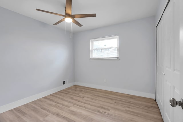 unfurnished bedroom with a closet, light wood-type flooring, baseboards, and a ceiling fan