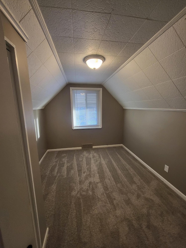 bonus room with visible vents, carpet, lofted ceiling, and baseboards