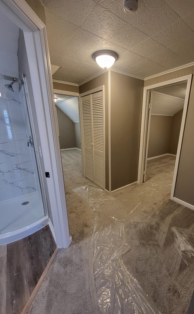 bathroom with baseboards, ornamental molding, and a stall shower