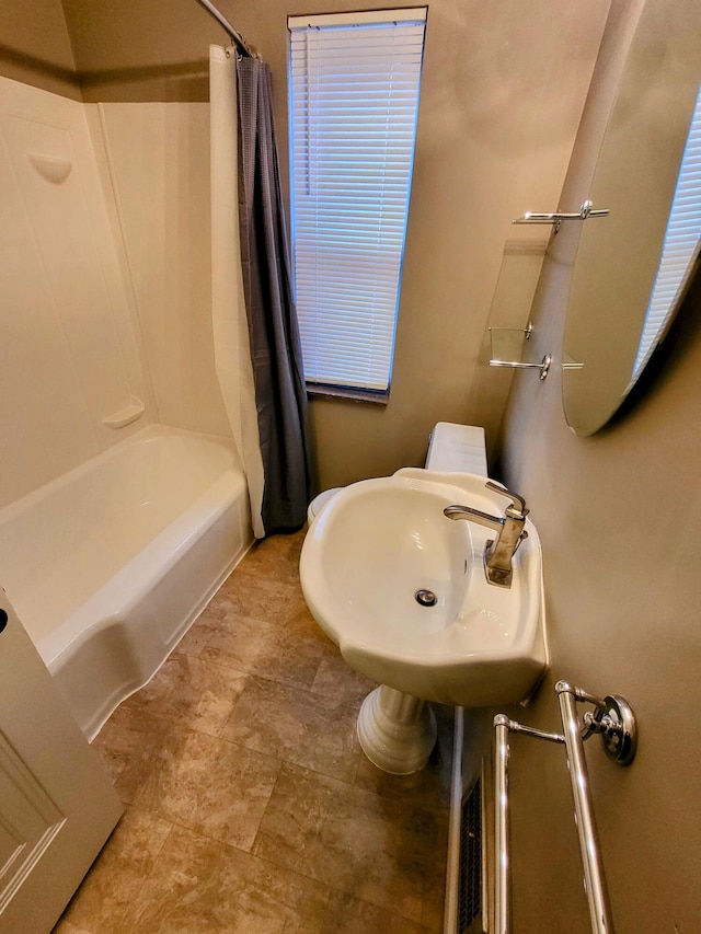 bathroom with a sink and shower / bath combo