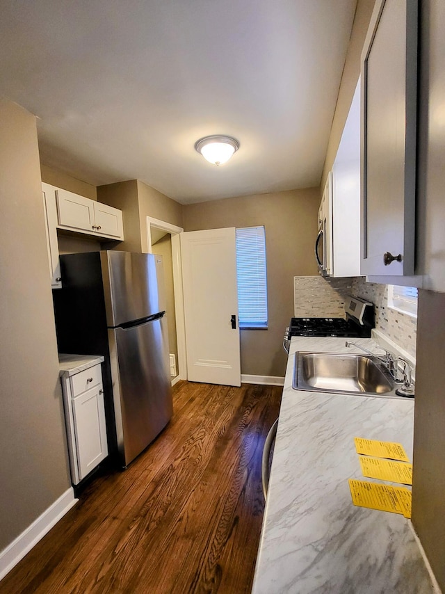 kitchen with light countertops, white cabinetry, dark wood-style floors, and stainless steel appliances