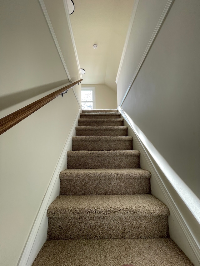 staircase featuring lofted ceiling
