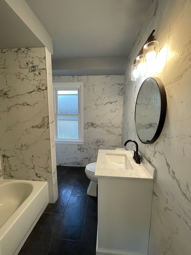 full bathroom featuring vanity, a bath, and toilet