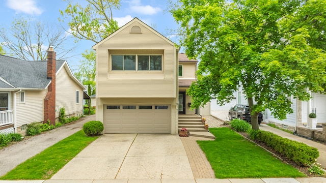view of front of home with an attached garage, concrete driveway, and a front yard