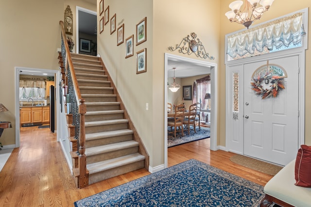53345 Williams Way, Shelby Twp, MI 48316 - foyer entrance featuring stairs, a towering ceiling, a healthy amount of sunlight, a chandelier, and light wood finished floors
