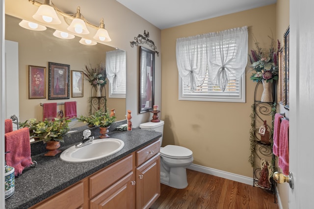 53345 Williams Way, Shelby Twp, MI 48316 - half bathroom featuring vanity, baseboards, toilet, and wood finished floors