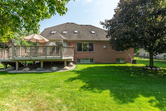 53345 Williams Way, Shelby Twp, MI 48316 - rear view of house with roof with shingles, central AC, brick siding, a deck, and a lawn
