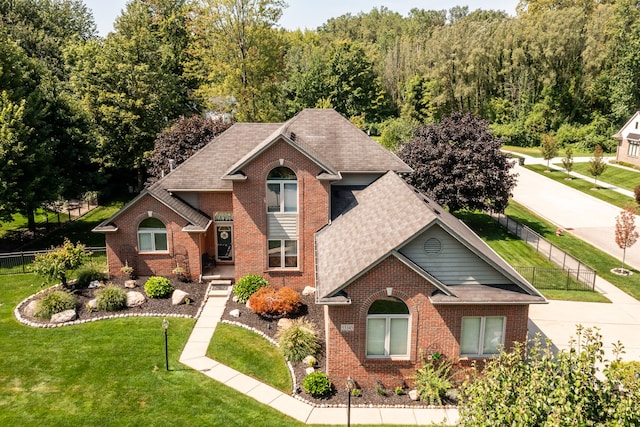 53345 Williams Way, Shelby Twp, MI 48316 - traditional home featuring brick siding, fence, and a front yard